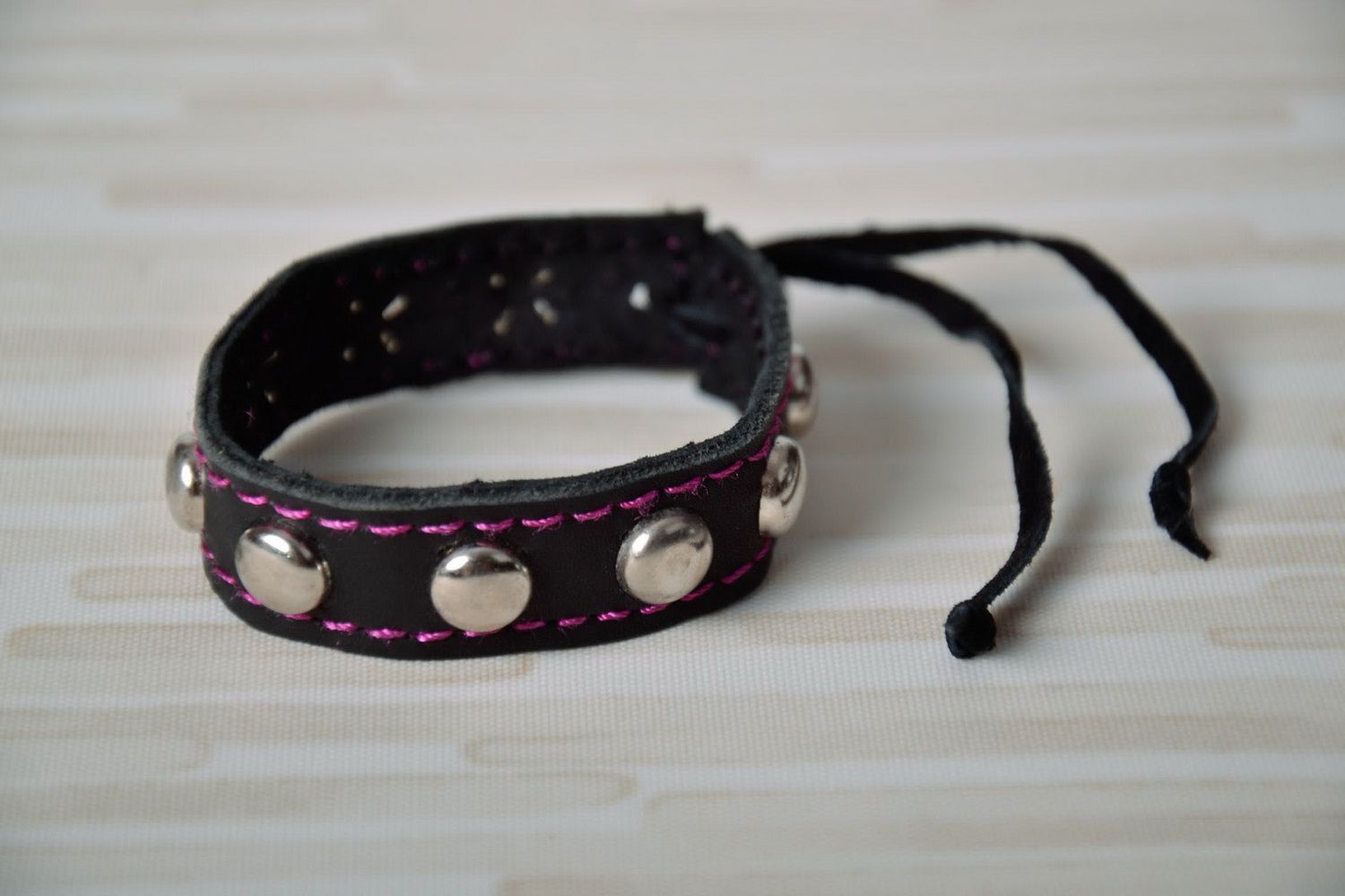 Black leather bracelet with pink line photo 1
