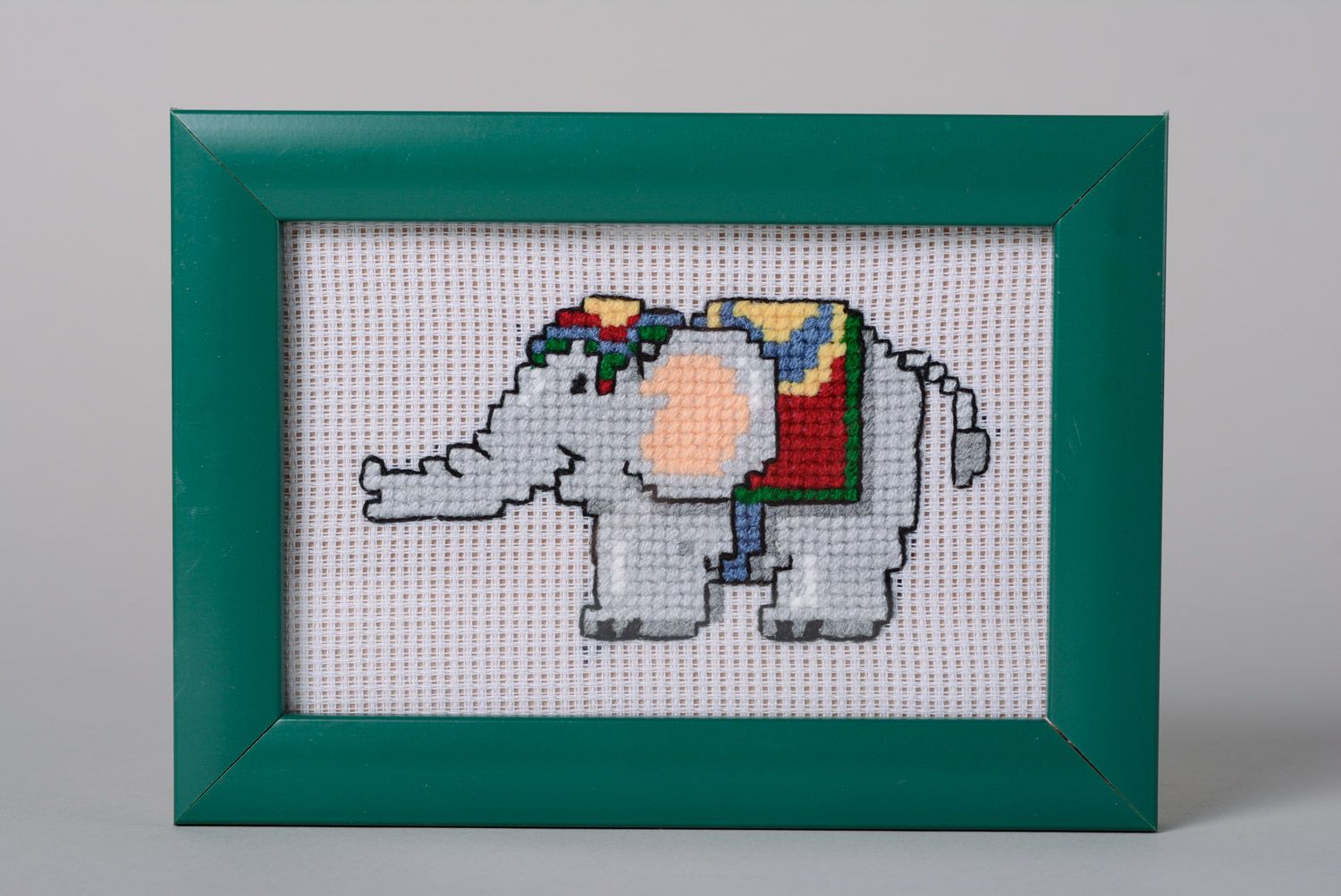 Handmade cross stitched picture of elephant in turquoise plastic frame photo 1