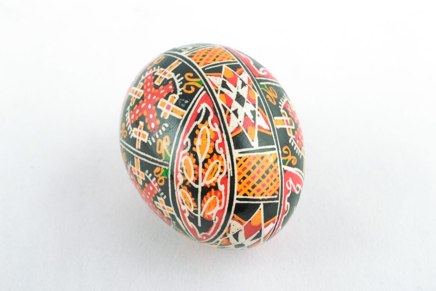 Handmade decorative painted chicken Easter egg with ornament on black background photo 3