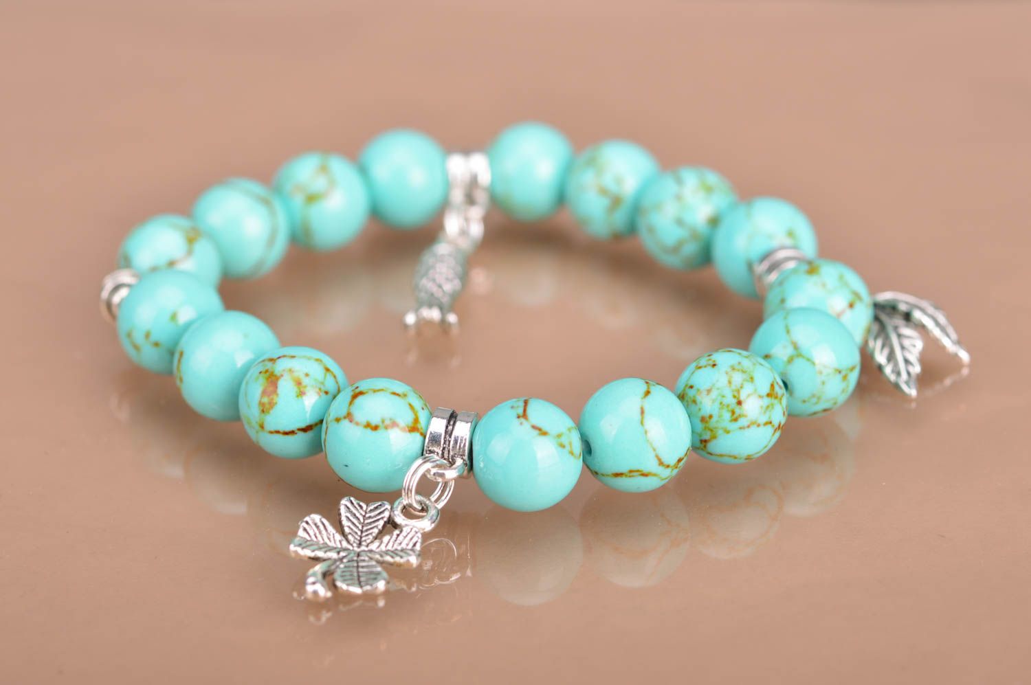 Handmade beaded wrist bracelet styled on turquoise with metal charms fish leaves photo 2