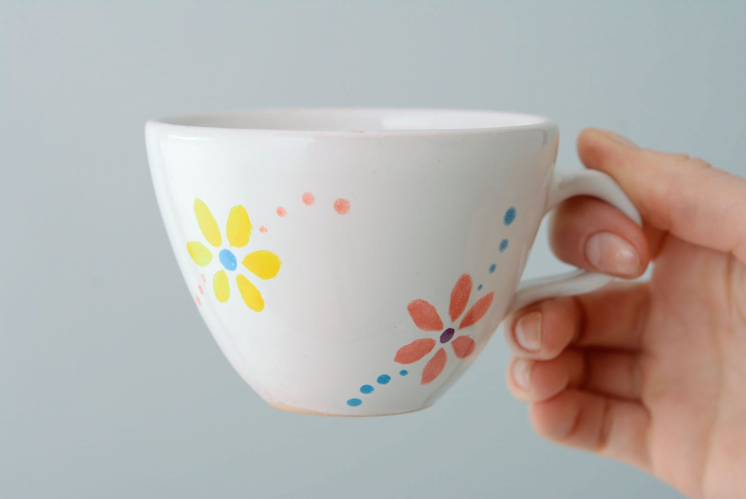 White ceramic drinking handmade 5 oz cup with handle and orange-blue flowers' pattern photo 3