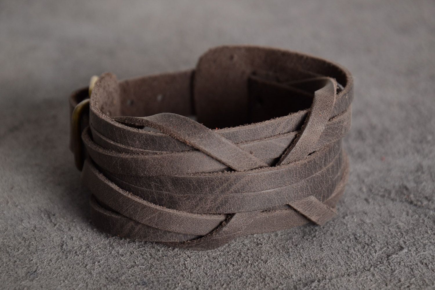 Handmade woven genuine leather wide bracelet of gray color with perforation photo 1
