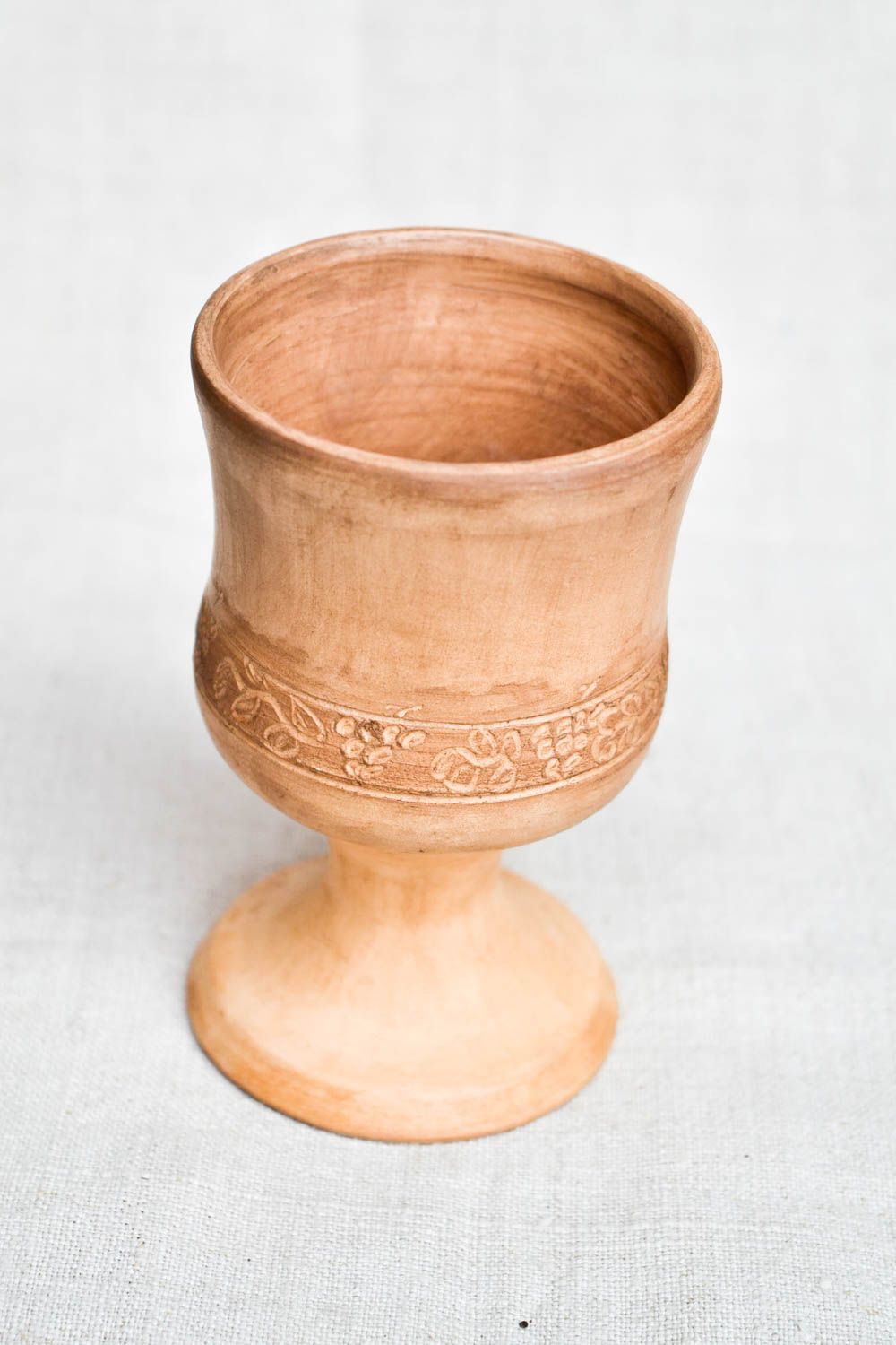 Light brown clay rustic drinking cup on stand with simple plain floral pattern photo 4