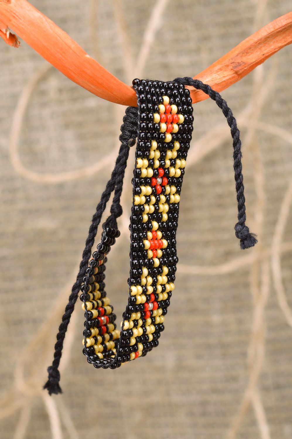 Handmade black wide beaded wrist bracelet with yellow and red flowers photo 1