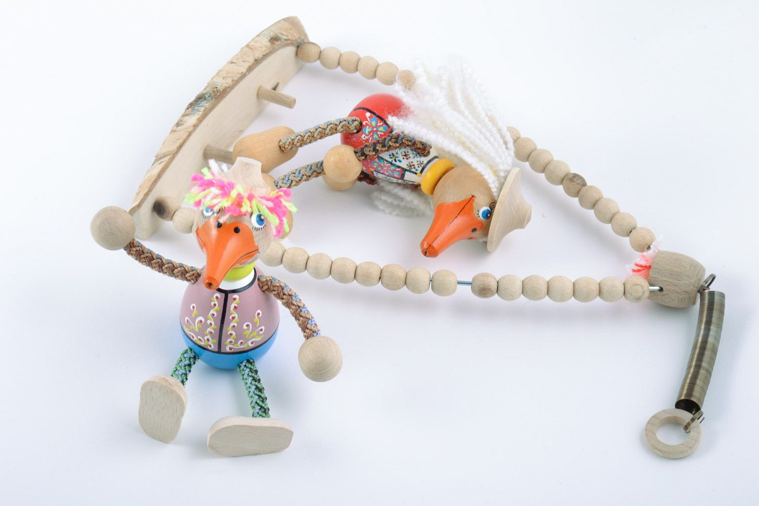Handmade painted wooden eco toys in the shape of 2 funny ducks sitting on swing photo 5
