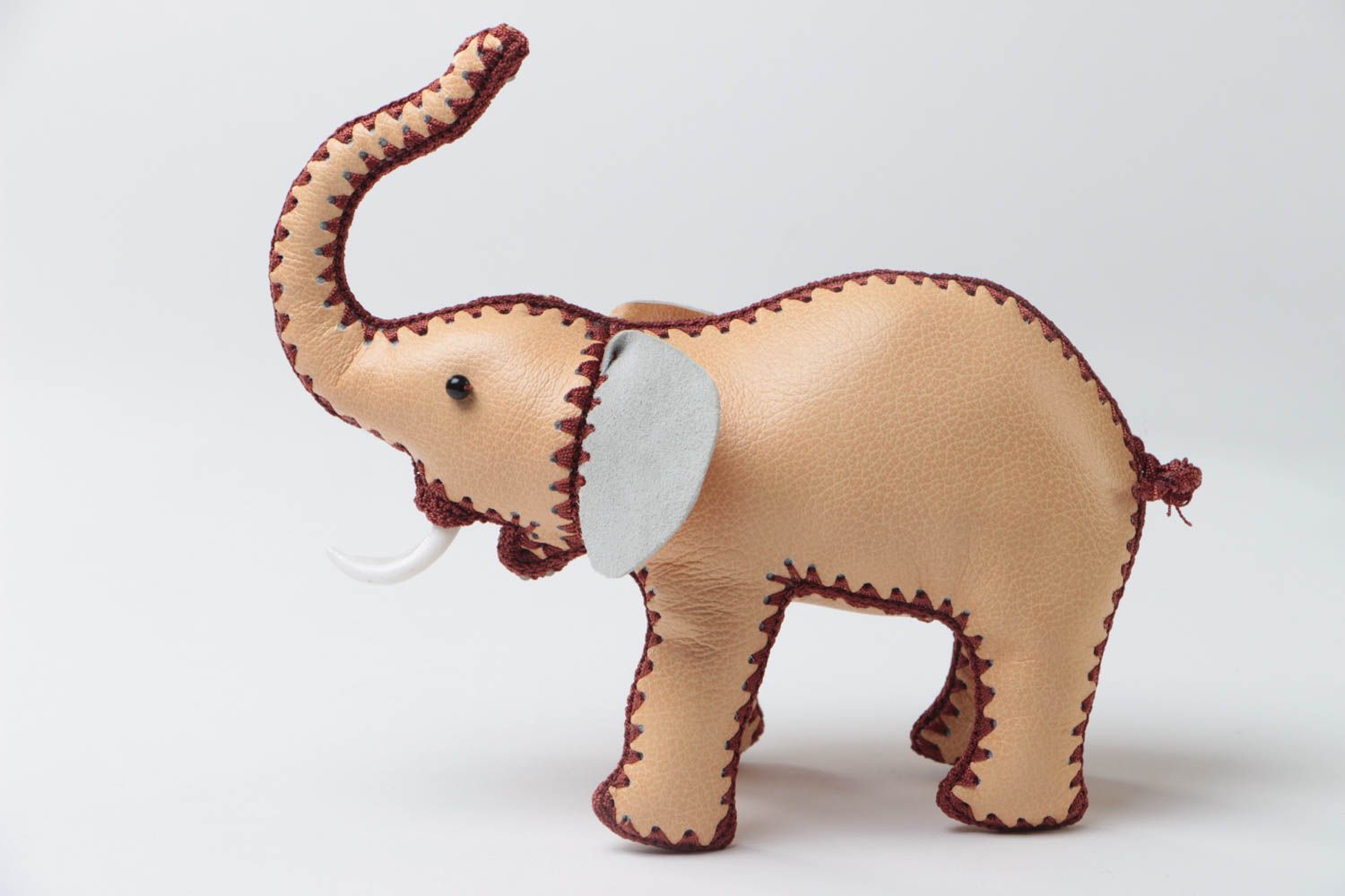 Handmade designer small soft toy elephant sewn of genuine leather of beige color photo 2