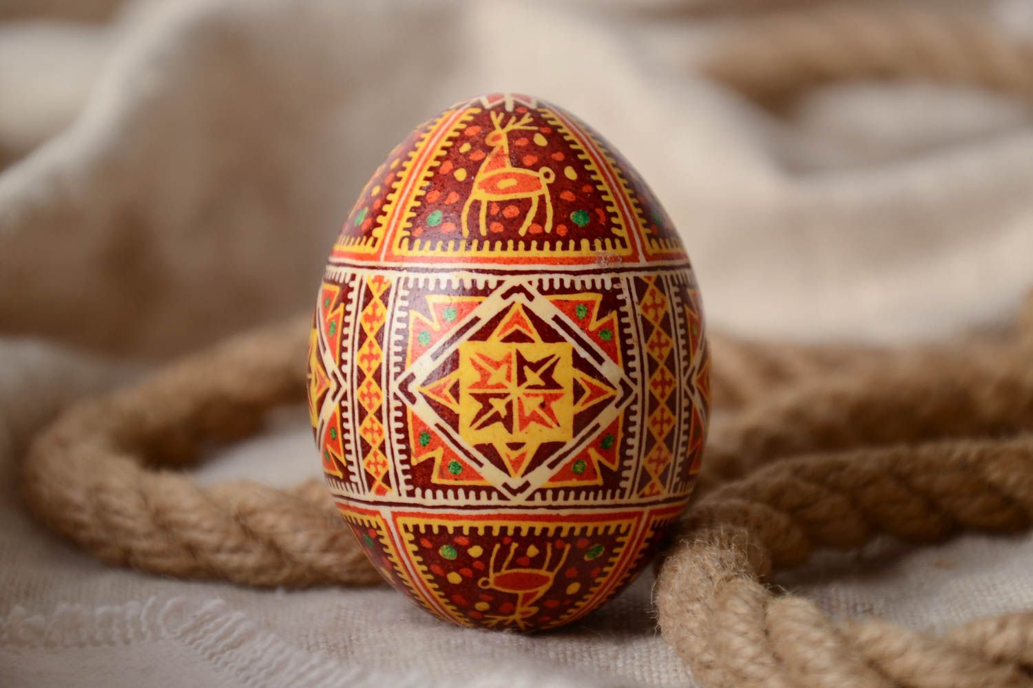 Homemade decorative souvenir Easter egg painted with hot wax and aniline dyes photo 1