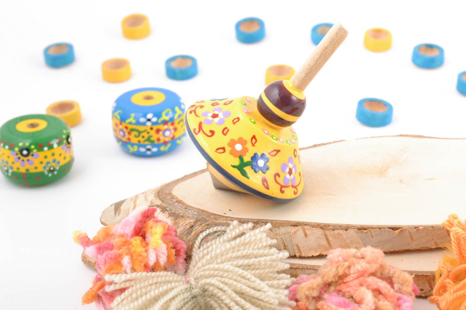 Handmade small painted with eco dyes wooden yellow spinning top toy for kids photo 1