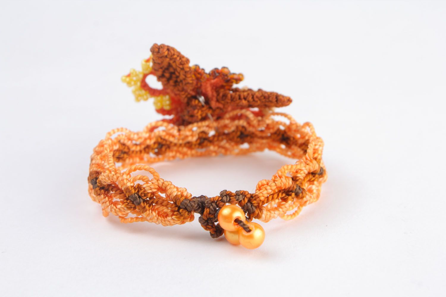 Bracelet made of threads and beads photo 3