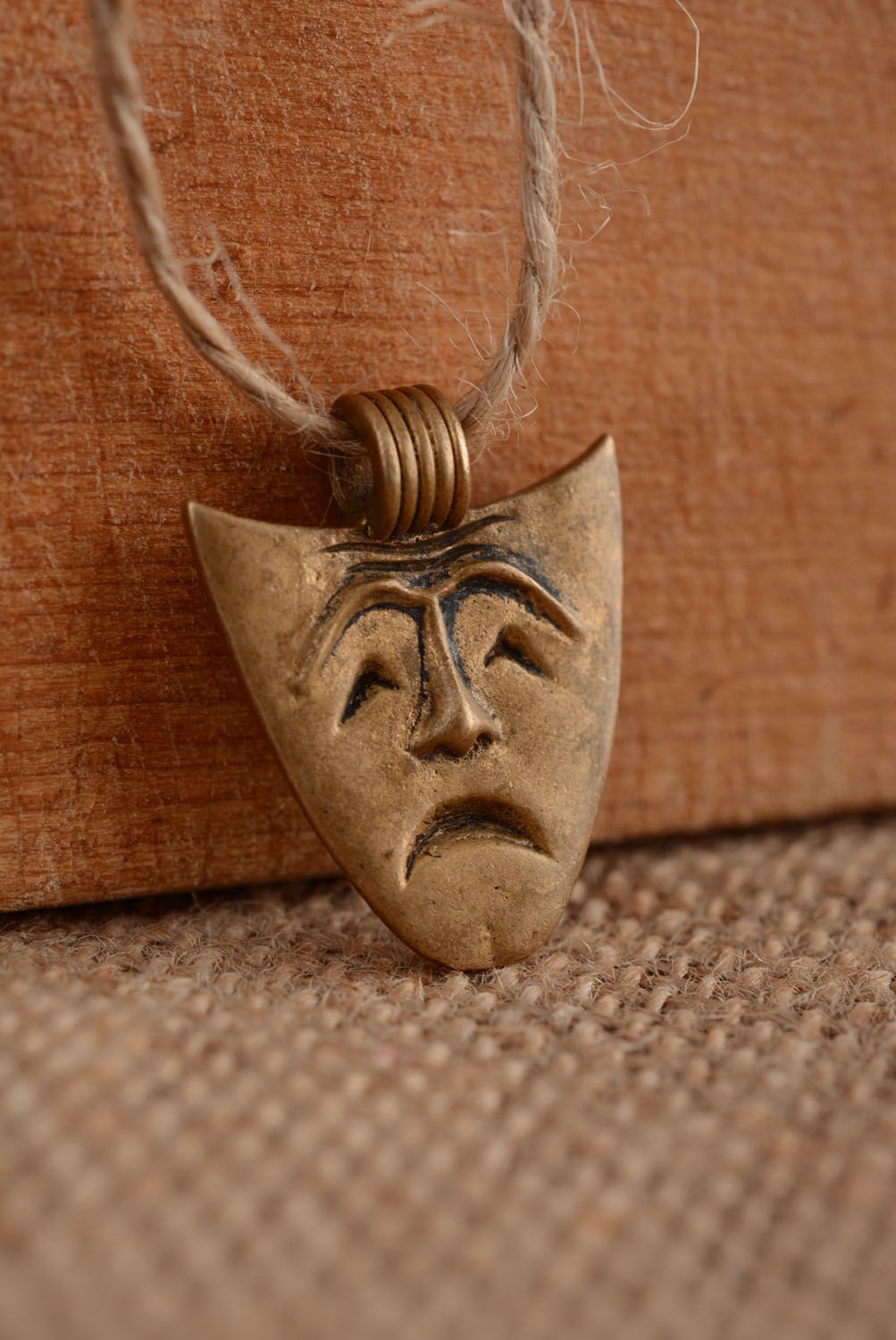 Bronze pendant in the shape of a mask photo 2
