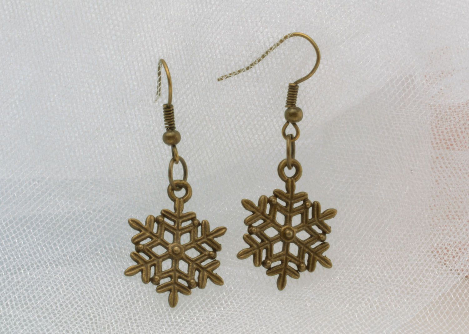Metal earrings in the shape of snowflakes photo 1