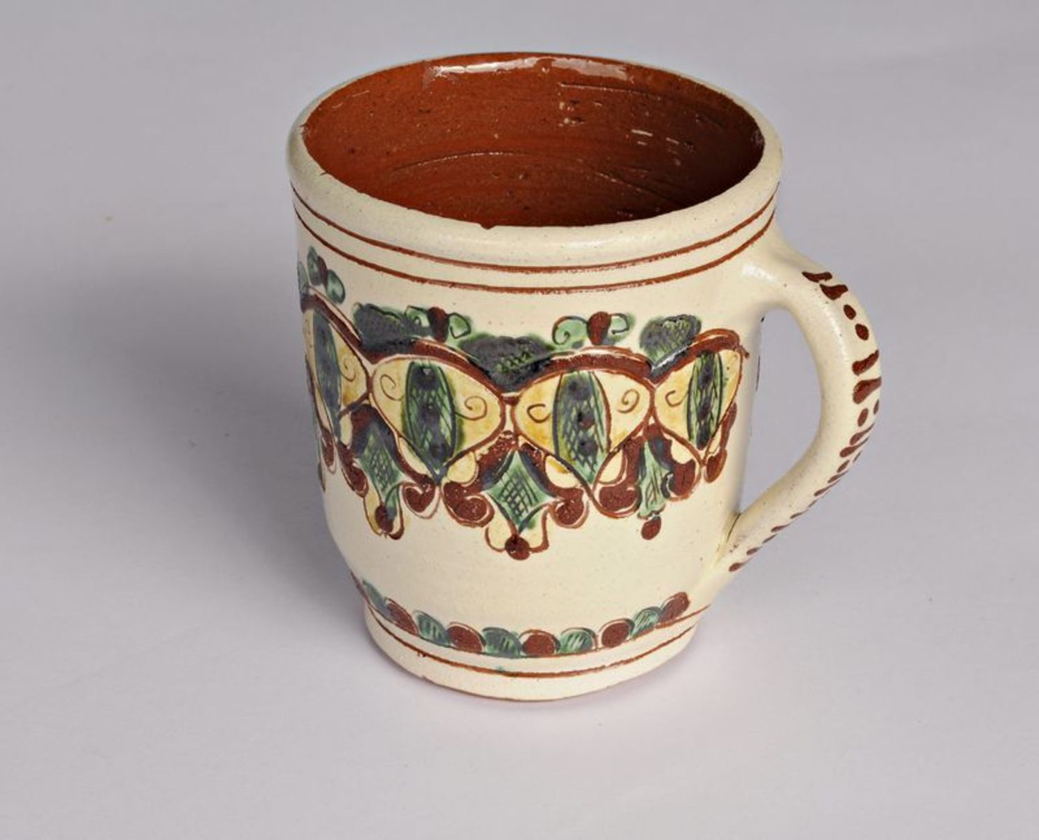 Art decorative handmade pottery clay cup in beige and green color with handle photo 1