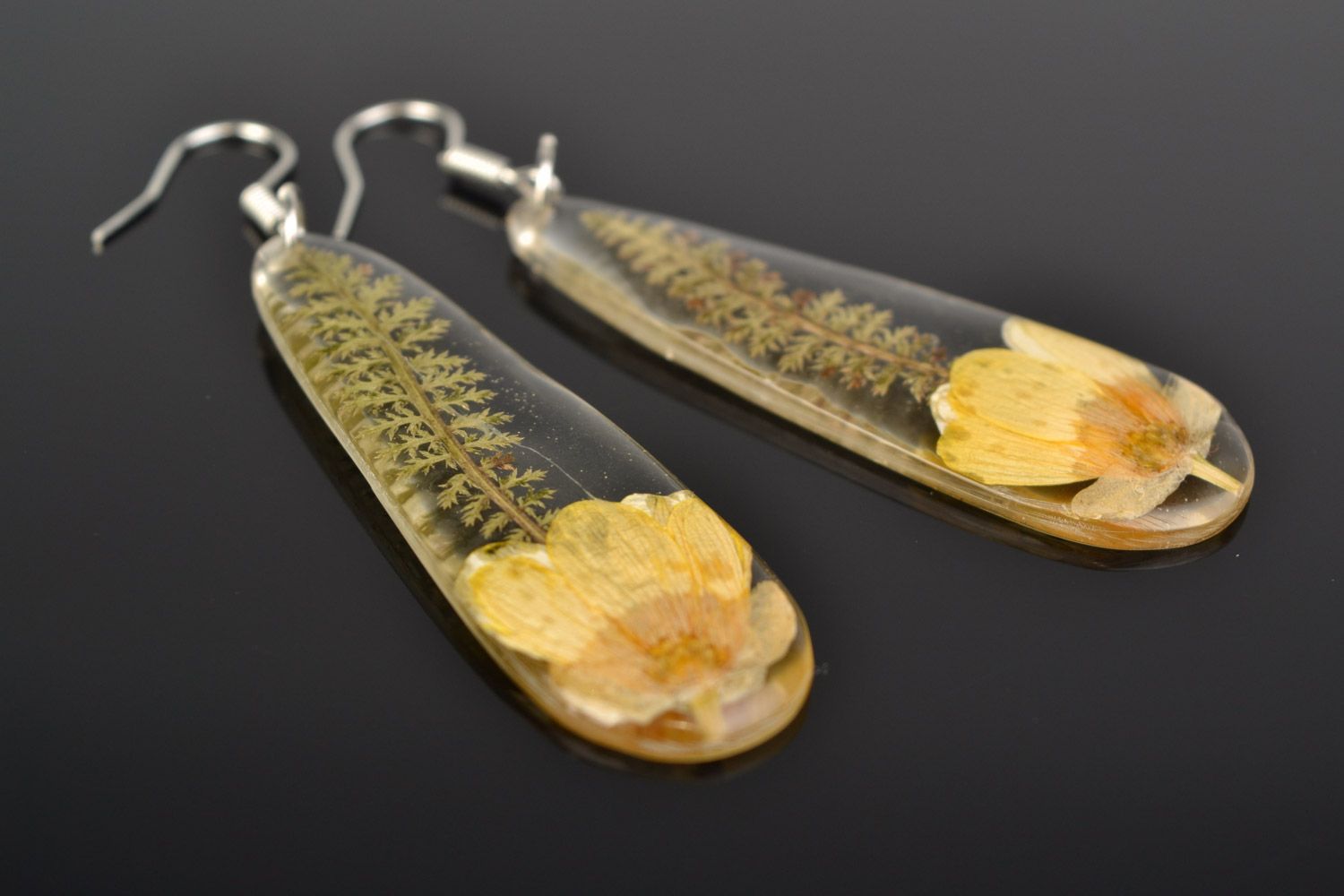 Handmade long drop-shaped dangle earrings with yellow-cup flower in epoxy resin photo 1