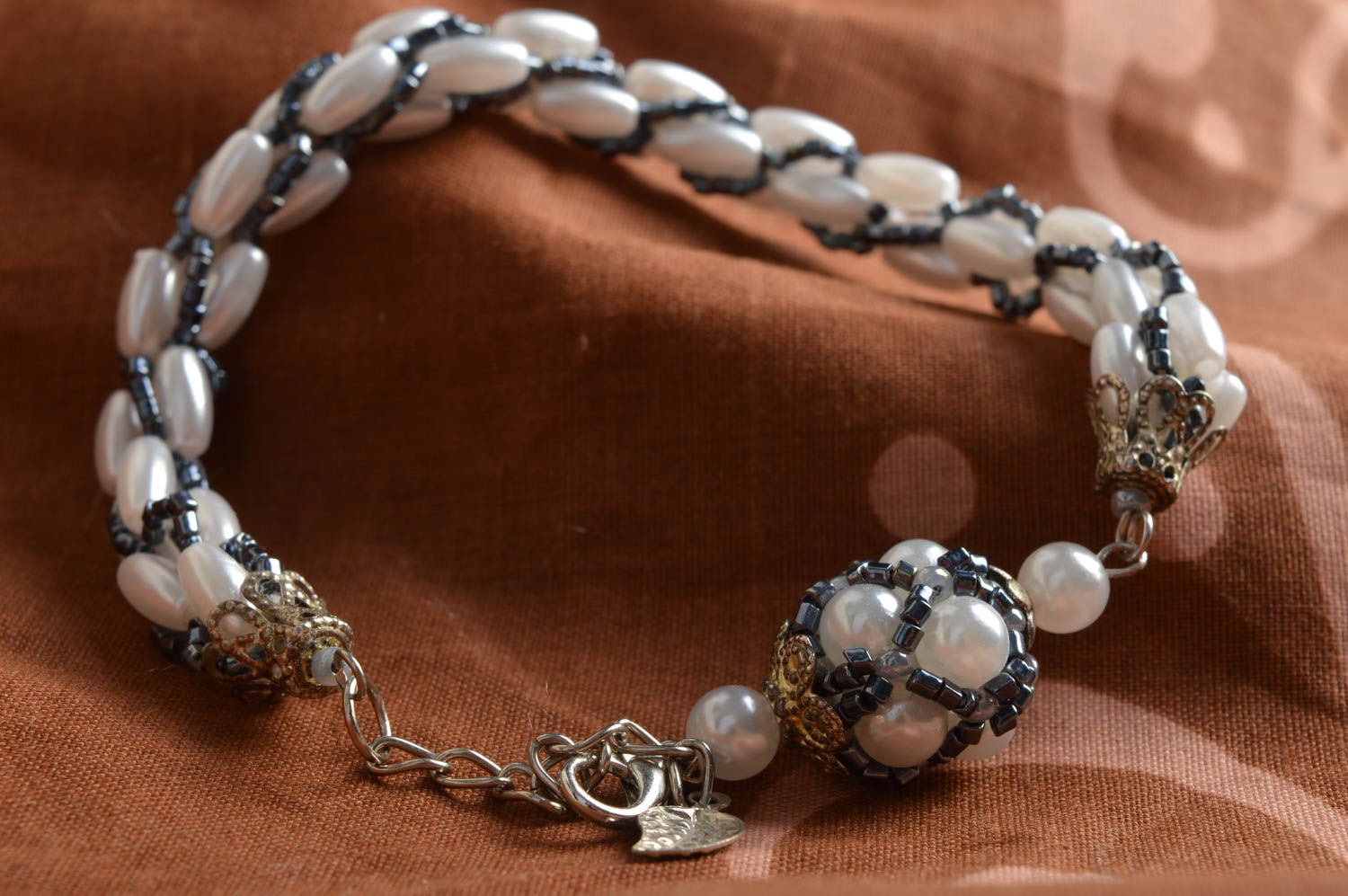 Handmade designer wrist bracelet with beads and faux pearls of white color photo 1