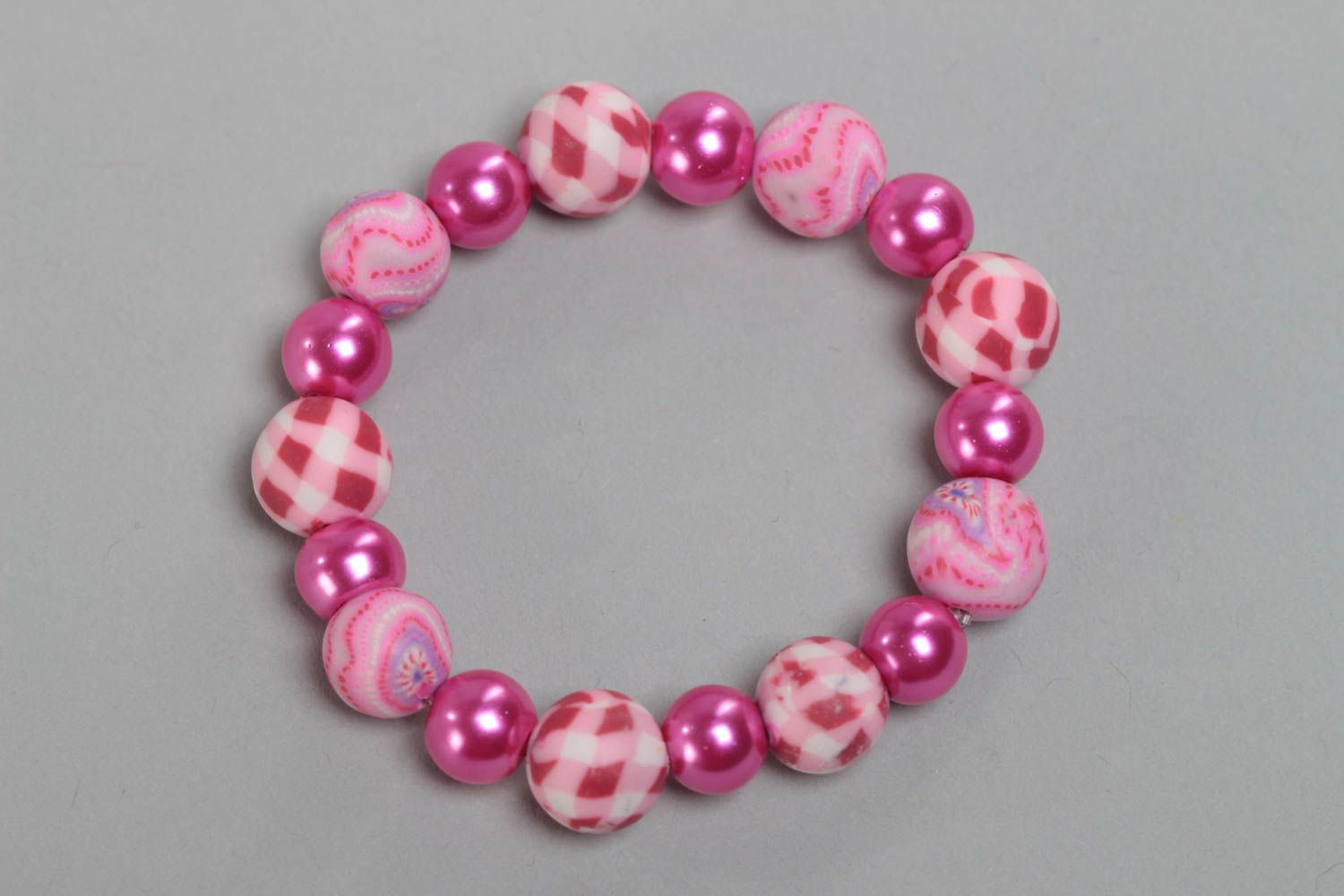 Pink children's handmade designer plastic bracelet with beads on elastic band photo 3