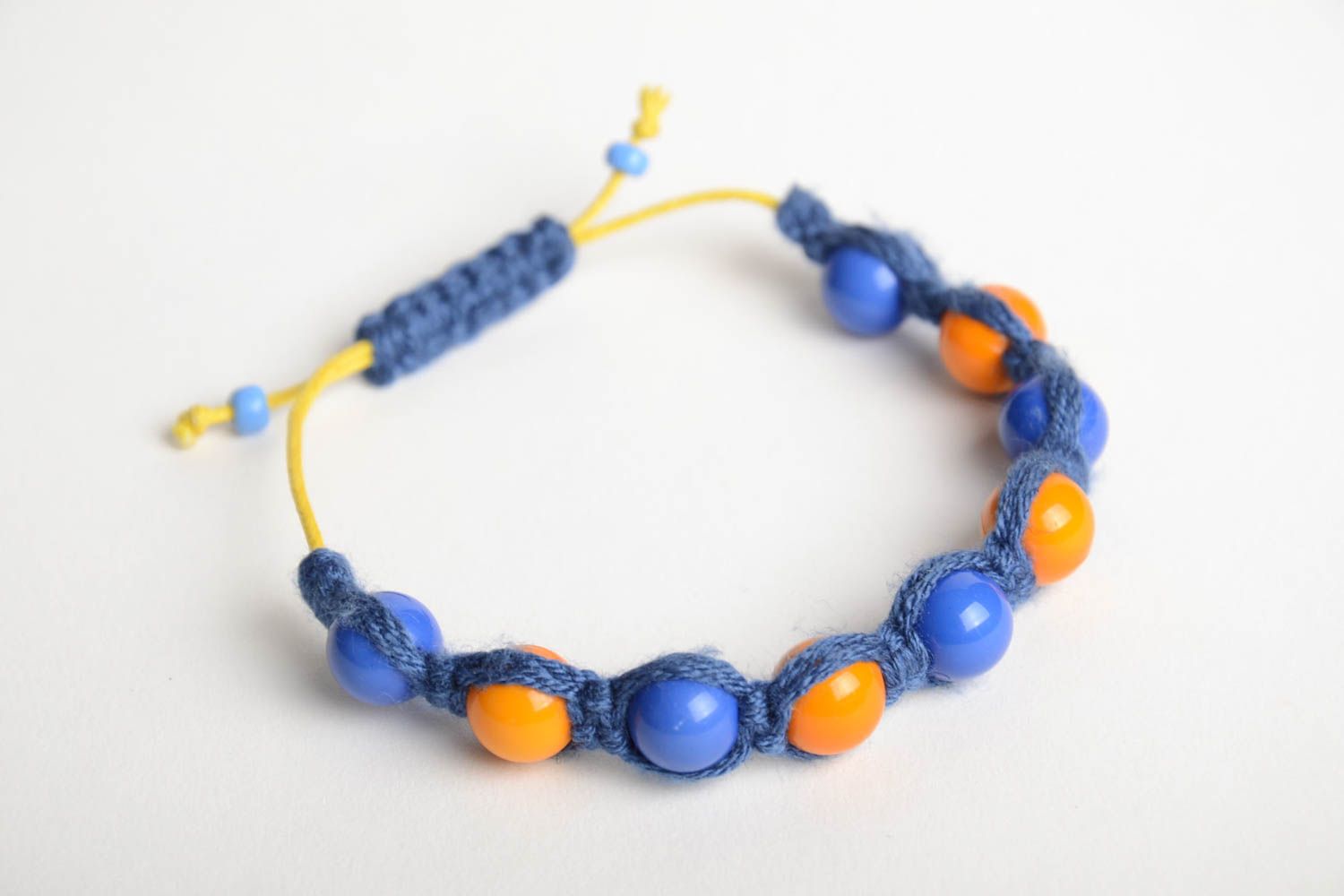 Handmade friendship bracelet woven of blue cord and orange beads for children photo 3