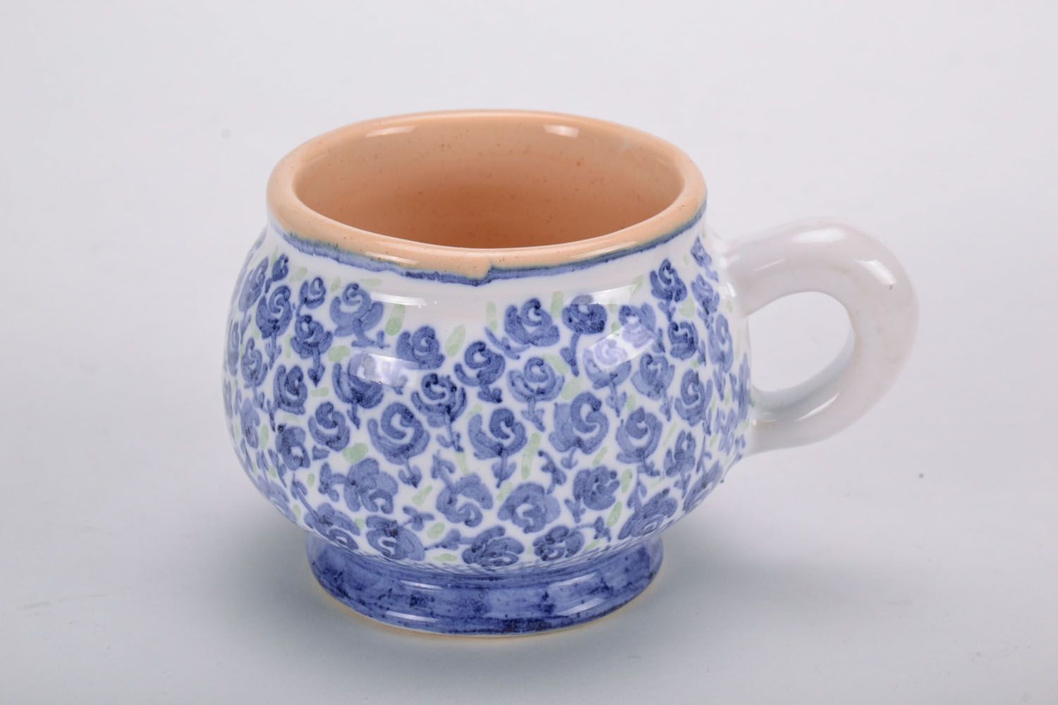 Handmade clay glazed drinking cup in white and blue color with violets' pattern photo 2