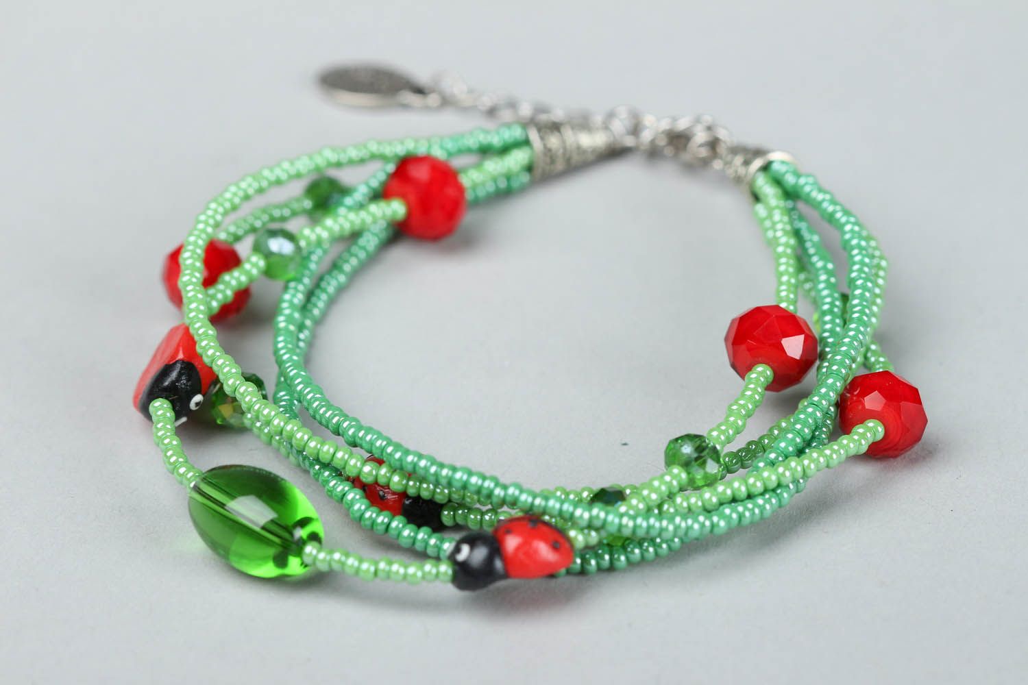 Green bracelet with ladybugs photo 2