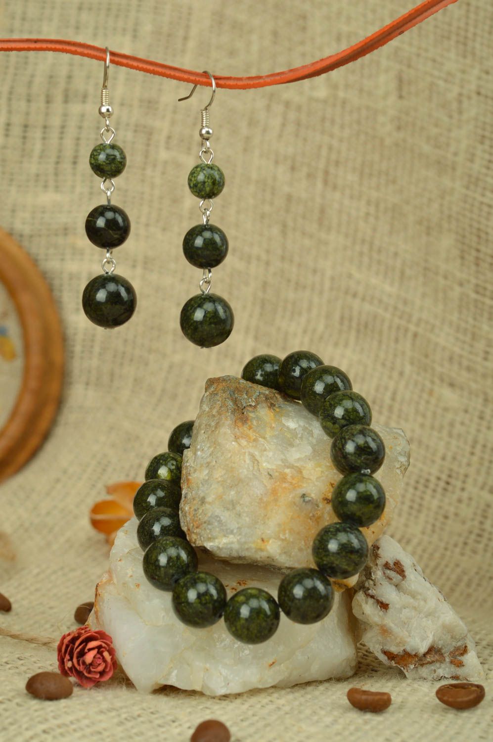 Set of handmade beaded jewelry earrings and bracelet styled on natural stone photo 1