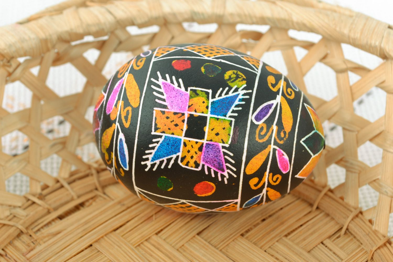 Decorative Easter egg with wax painting of black color with traditional patterns photo 1