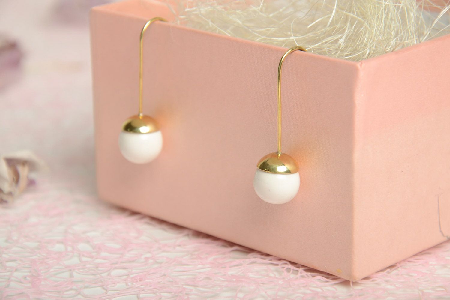 Stylish white handmade ceramic ball earrings with brass frame photo 1