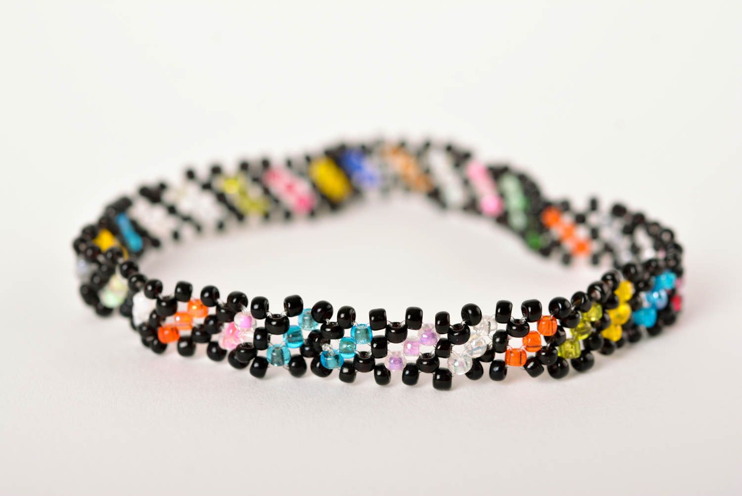 Thin handmade beaded bracelet made of black, green, red yellow beads for young girls photo 4