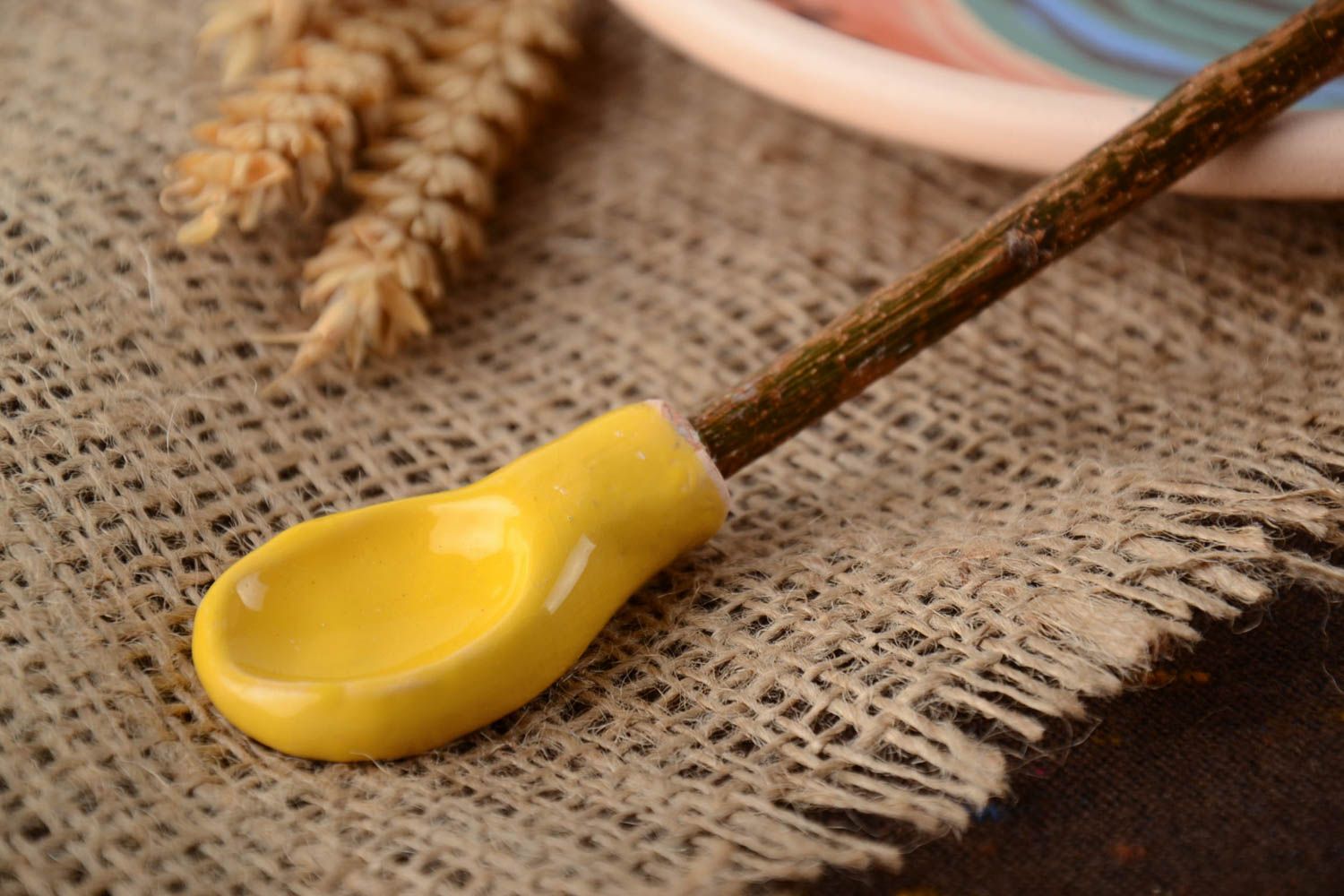 Handmade designer yellow clay spoon with apricot branch handle photo 1