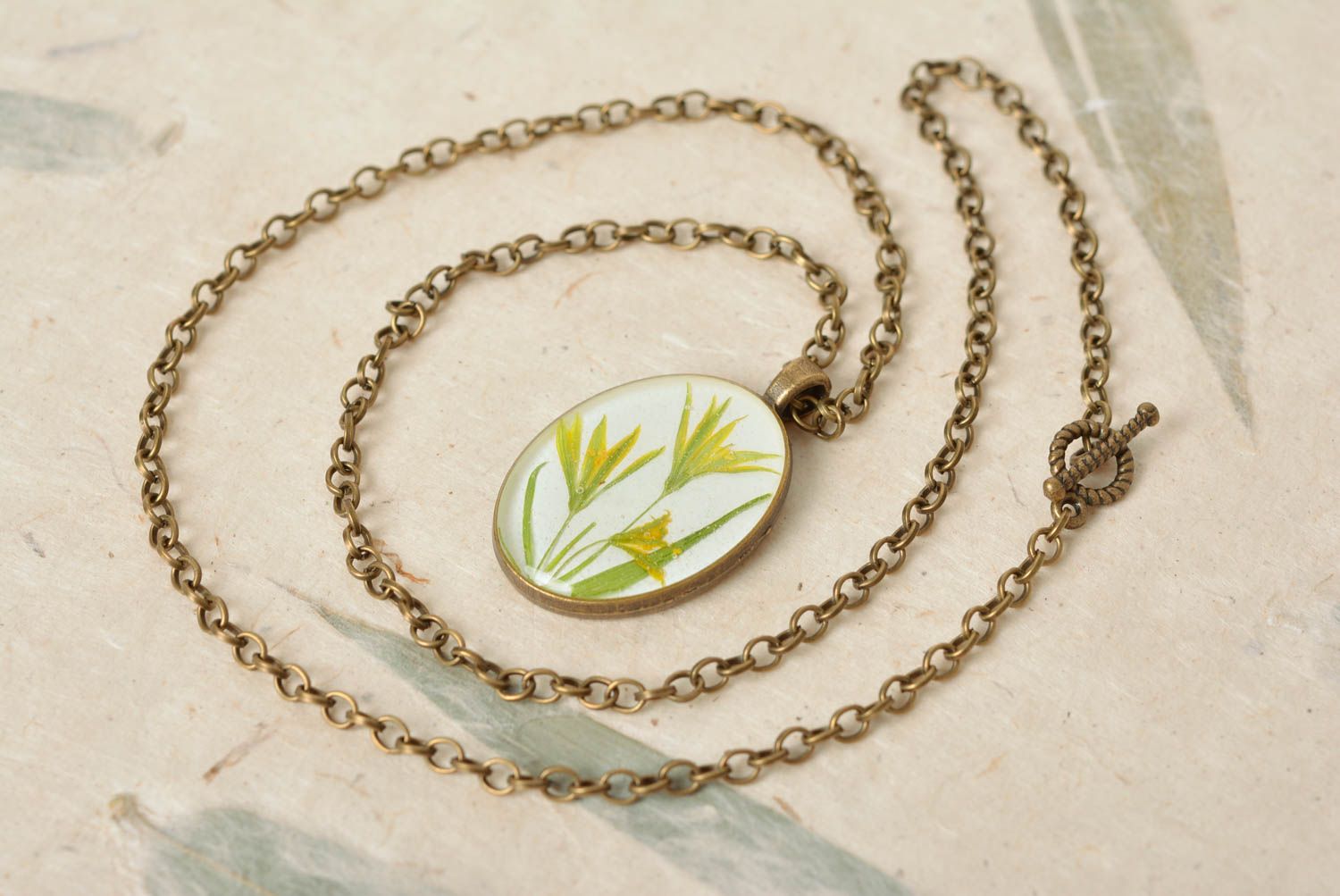 Handmade designer oval white pendant with dried flowers in epoxy resin on chain photo 1