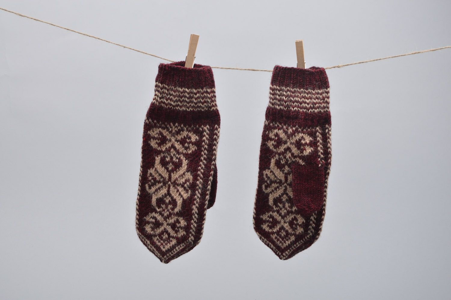 Homemade warm winter knit woolen mittens with ornaments in brown color palette photo 5