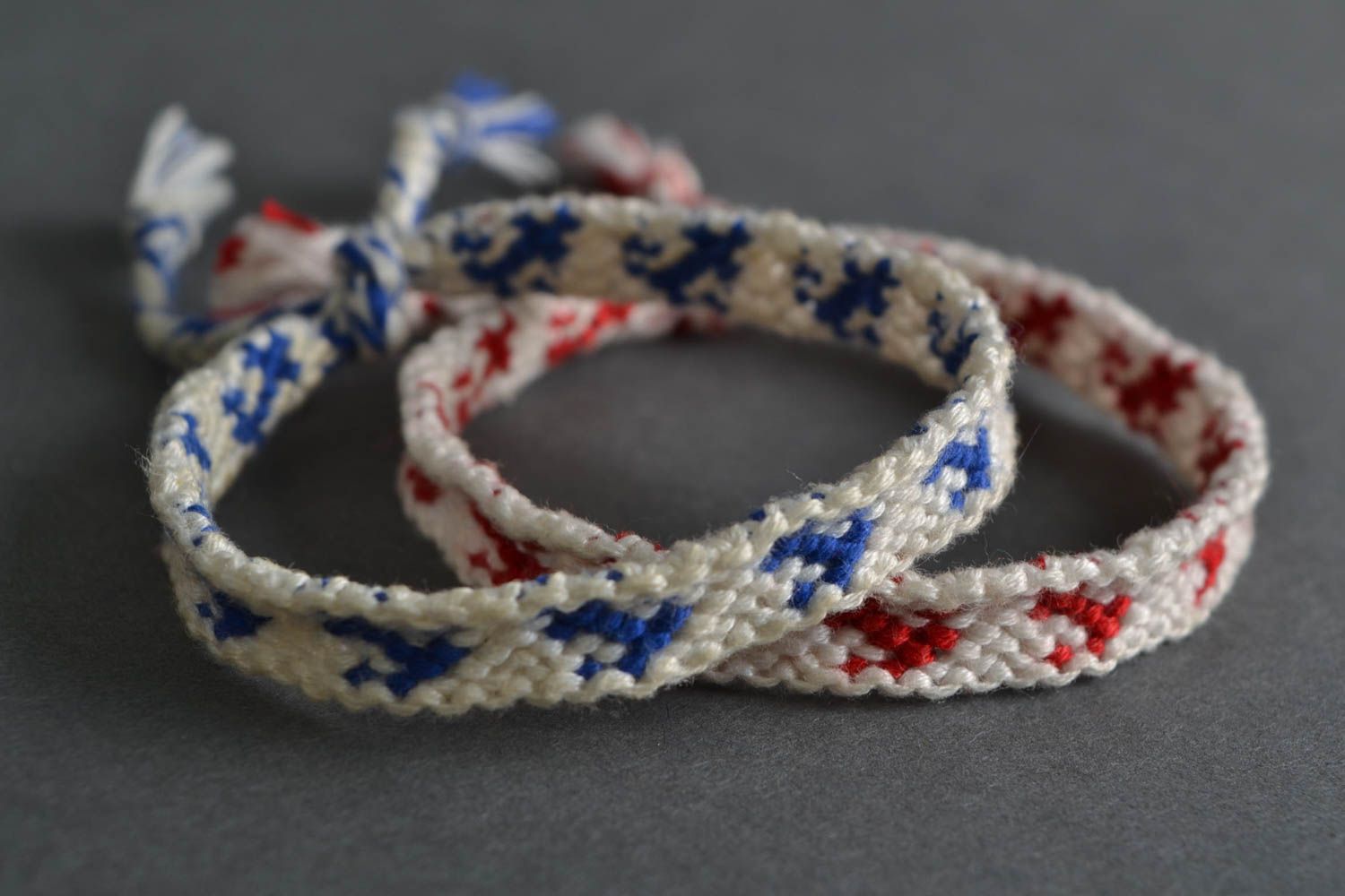 Set of 2 handmade white friendship wrist bracelets with red and blue inserts photo 1