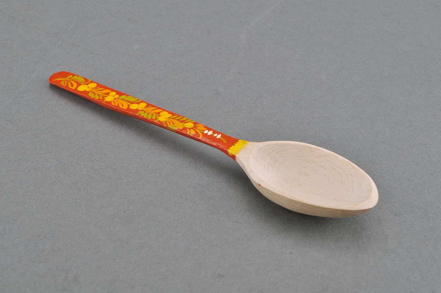 Wooden teaspoon with orange handle photo 1