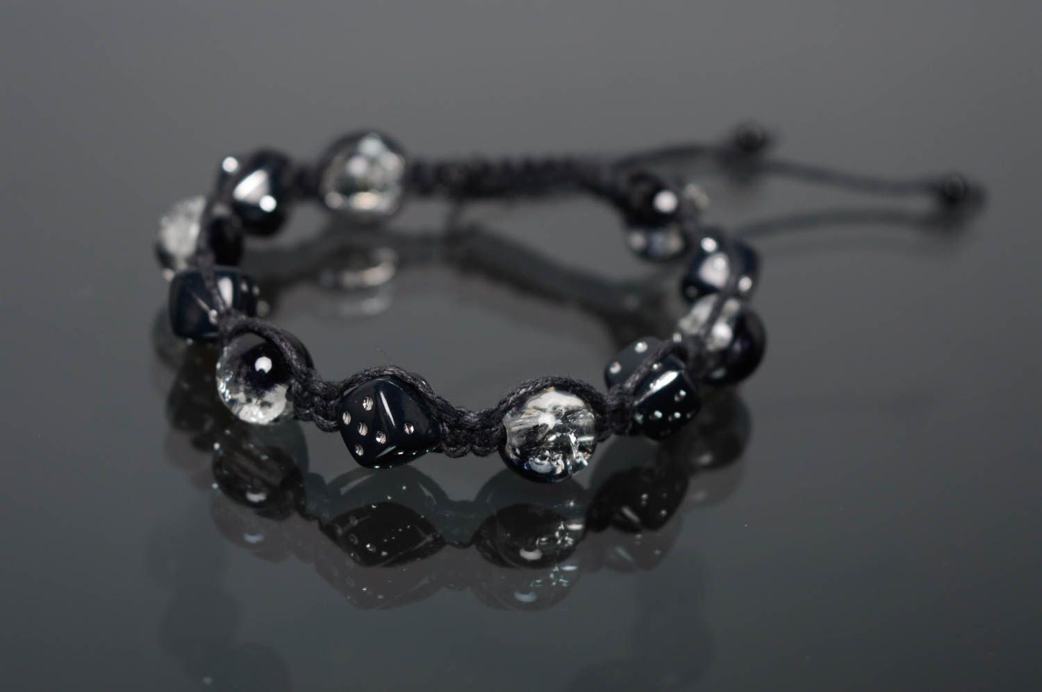Woven bracelet with beads of dark color photo 1