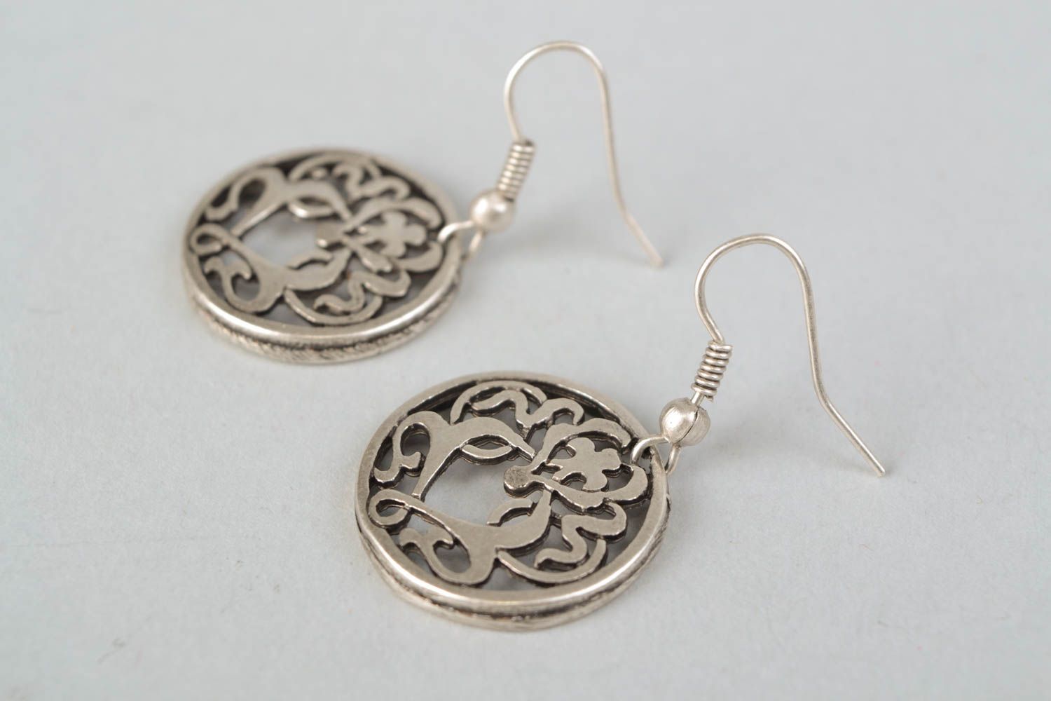 Round metal earrings with curls photo 4