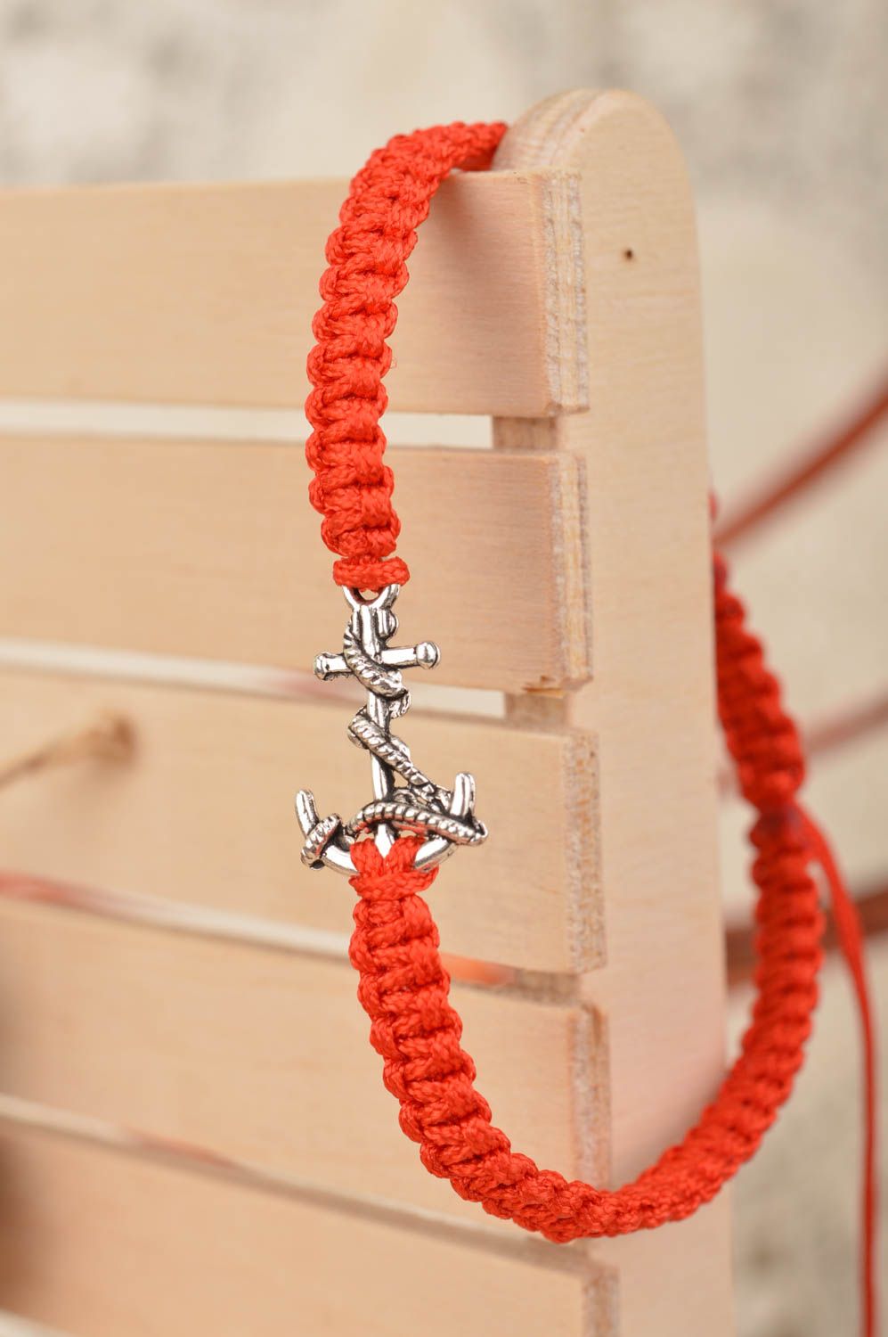 Handmade stylish thin red woven wrist bracelet made of silk with insert photo 1