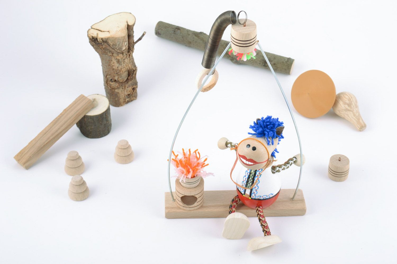 Handmade wooden eco toy with painting horse in folk costume on swing photo 1
