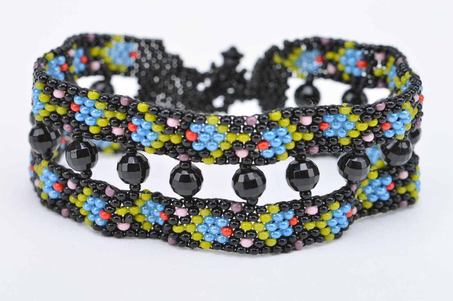 Handmade wide bracelet woven of black seed and faceted beads with flowers photo 4