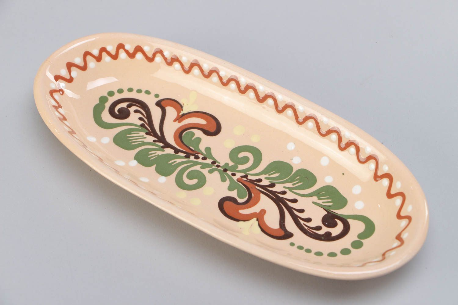 Homemade long ceramic dish ornamented with colorful glaze for serving fish photo 3