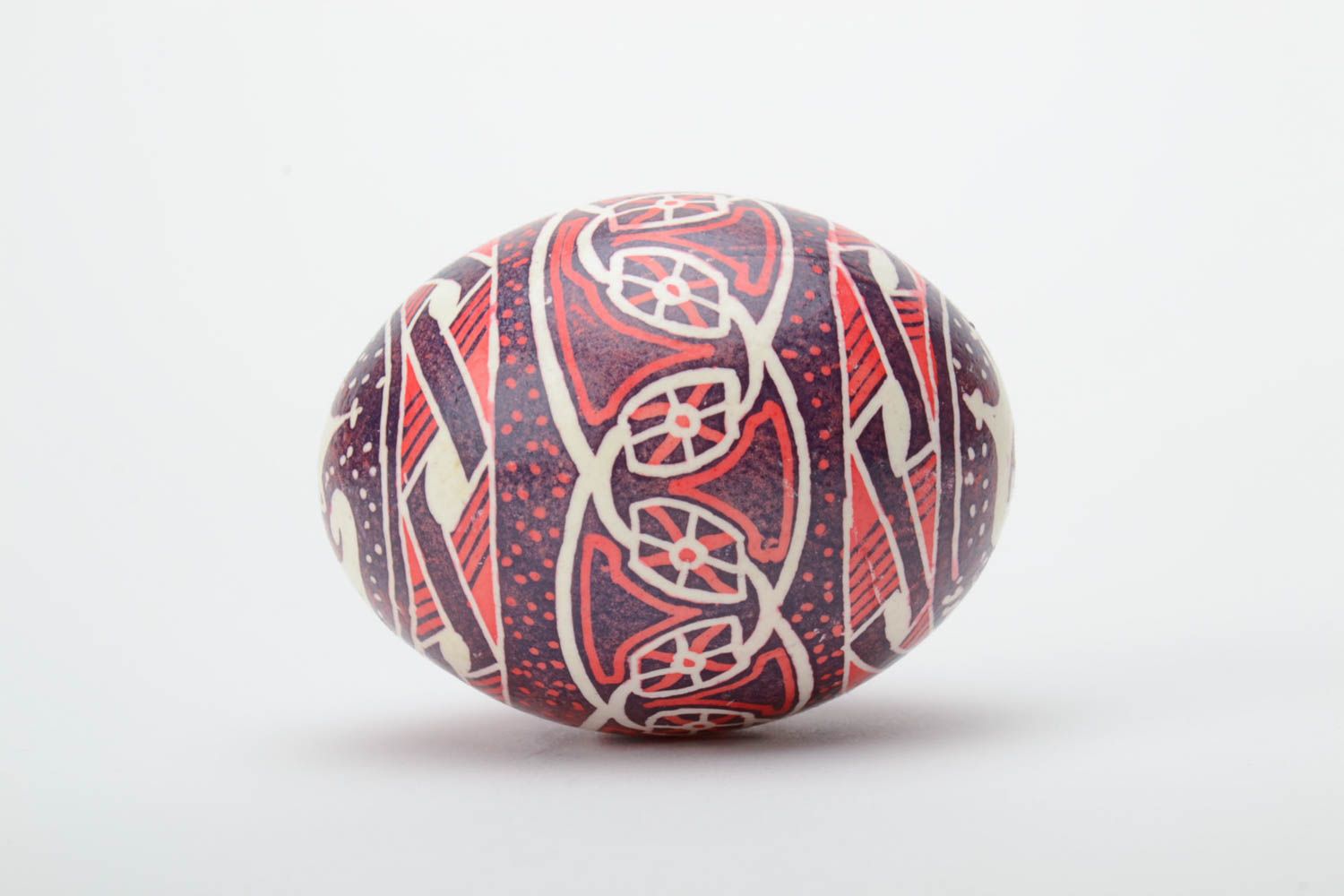 Homemade decorative ethnic painted Easter egg pysanka in red color palette photo 3
