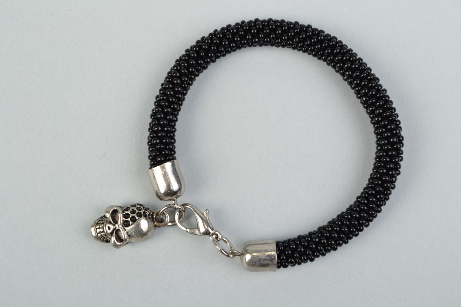 Handmade beaded cord women's wrist bracelet in black color with skull charm photo 2
