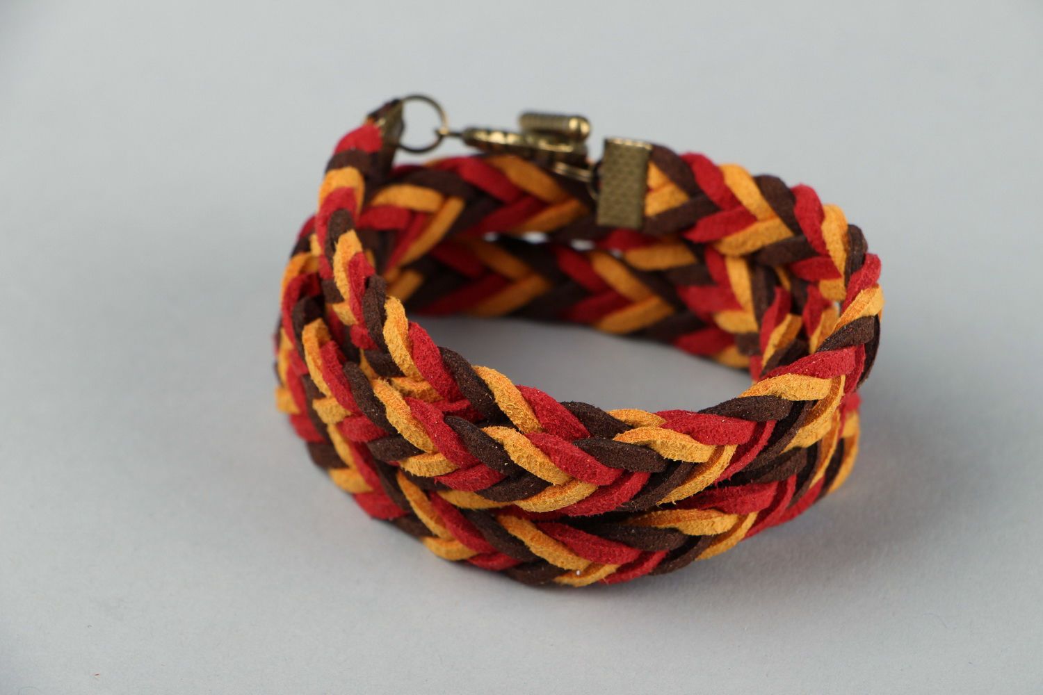 Braided suede bracelet of red and brown colors photo 1