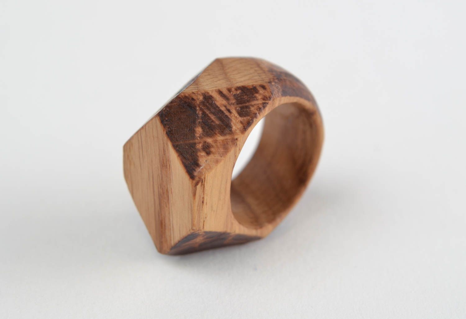Handmade stylish designer jewelry ring cut out of natural oak wood with facets photo 5