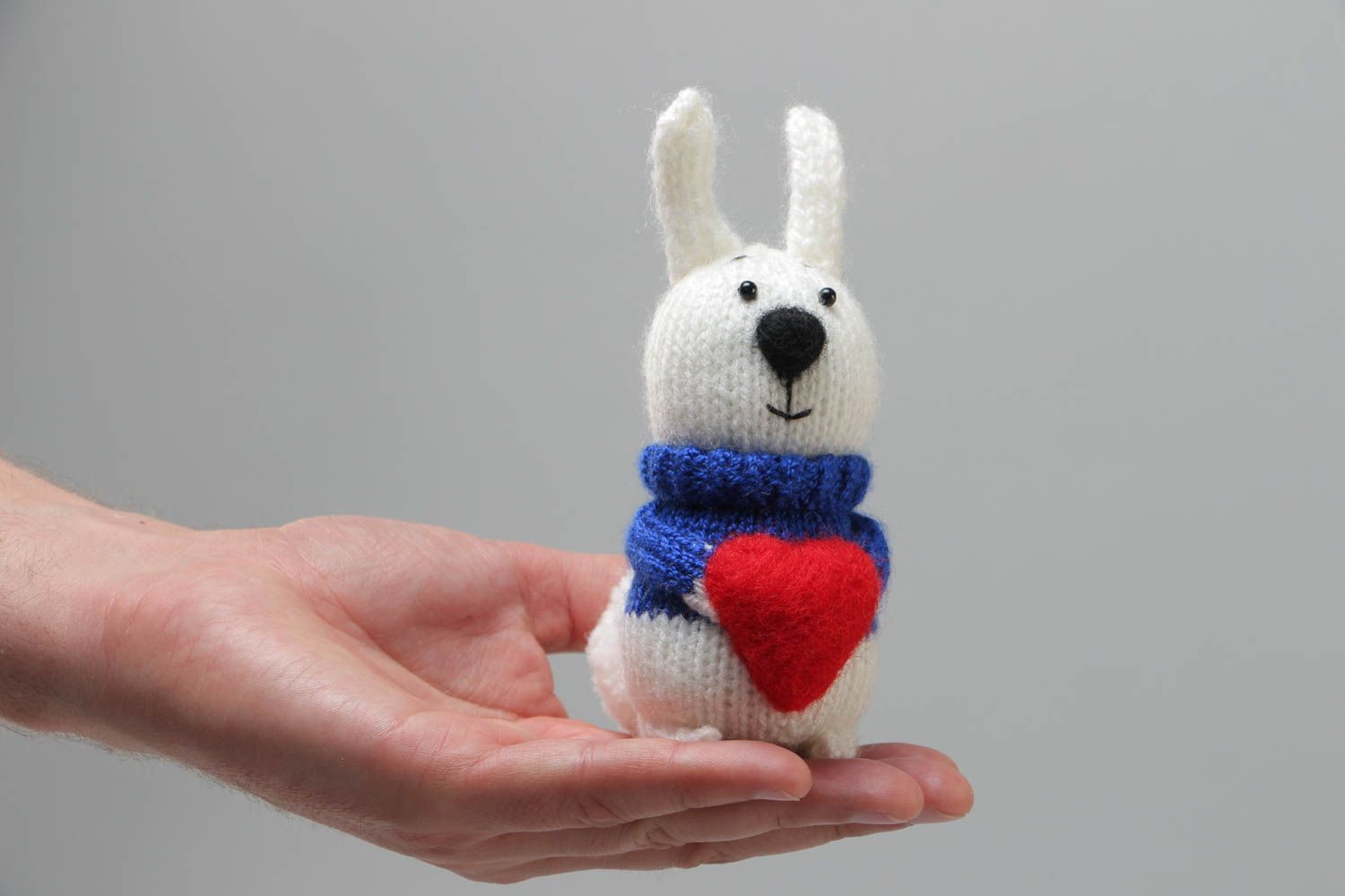 Handmade soft knitted white rabbit toy with a red heart for children photo 5