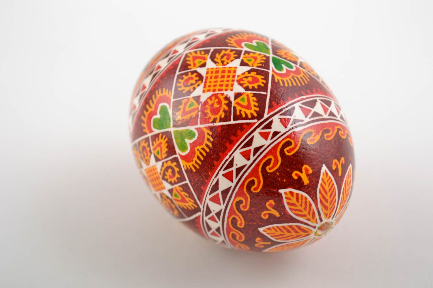 Decorative handmade painted Easter egg with ornament in red color palette photo 3