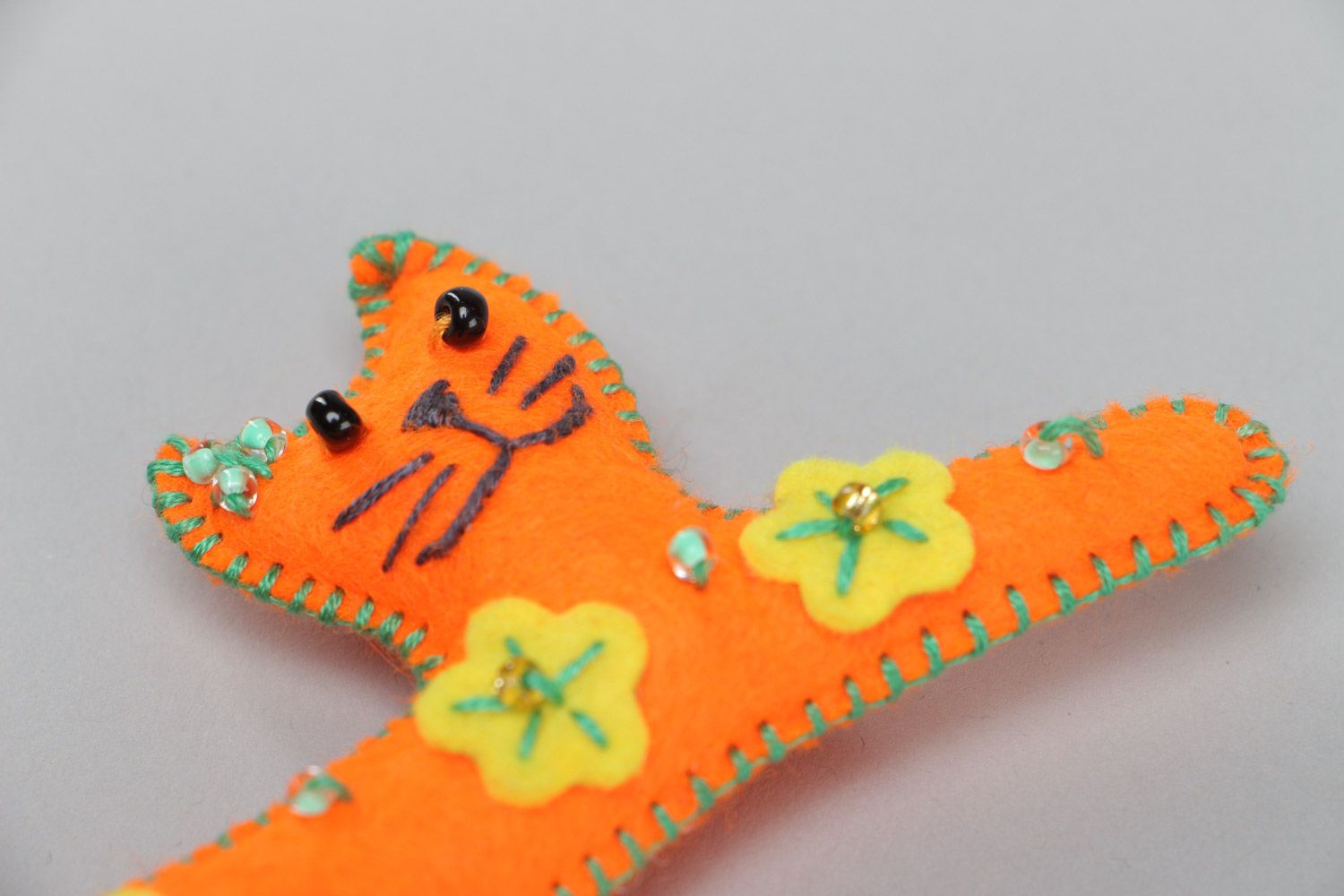 Handmade small soft toy sewn of felt in the shape of long orange kitten  photo 3