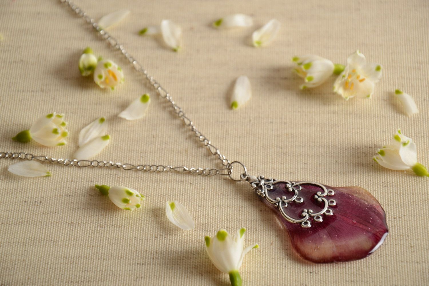 Handmade pendant on long chain with flower petal coated with epoxy resin photo 1