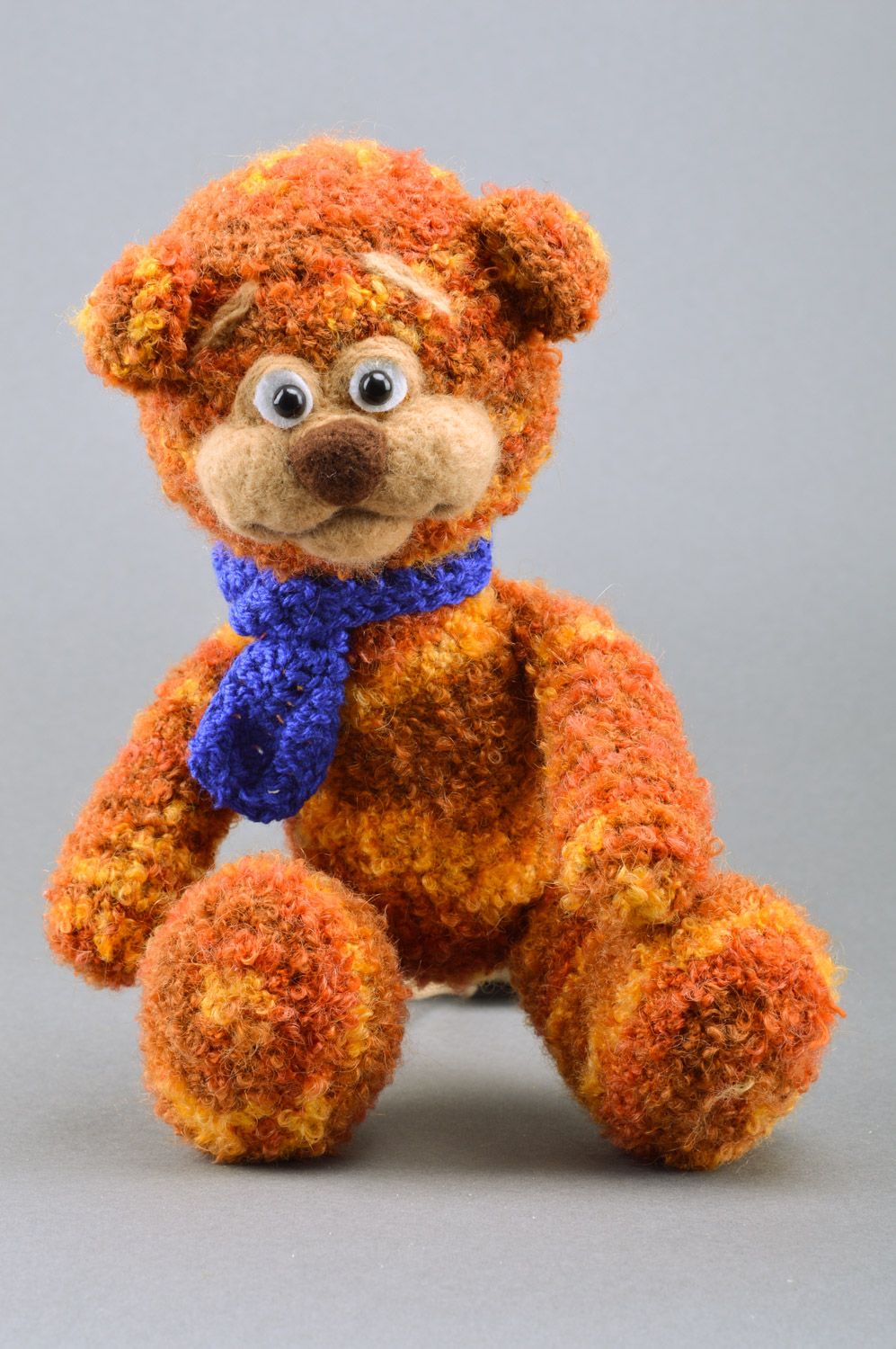 Handmade crochet soft toy in the shape of brown bear with blue scarf for children photo 2
