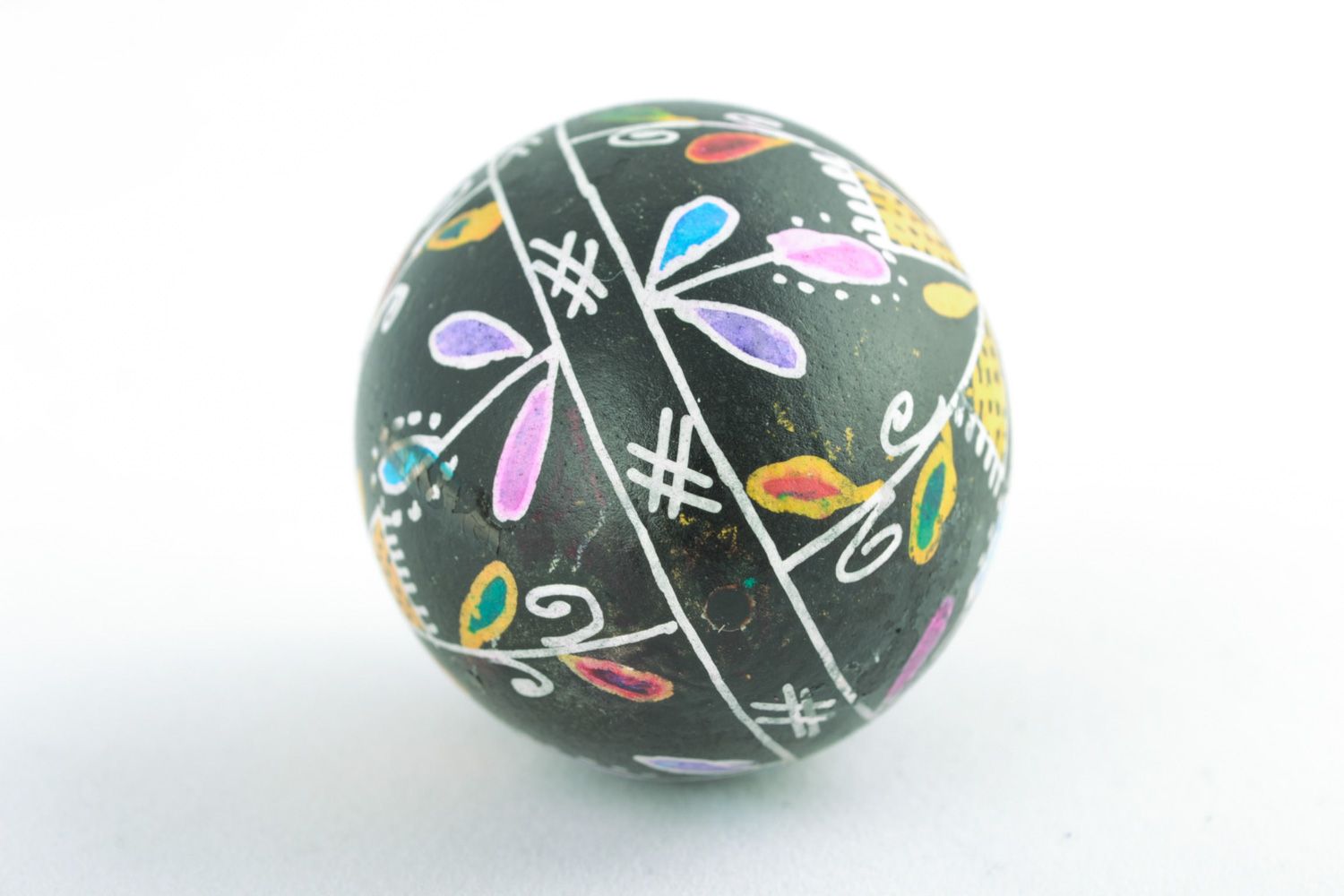 Handmade Easter egg with floral ornament on black background painted with wax photo 5
