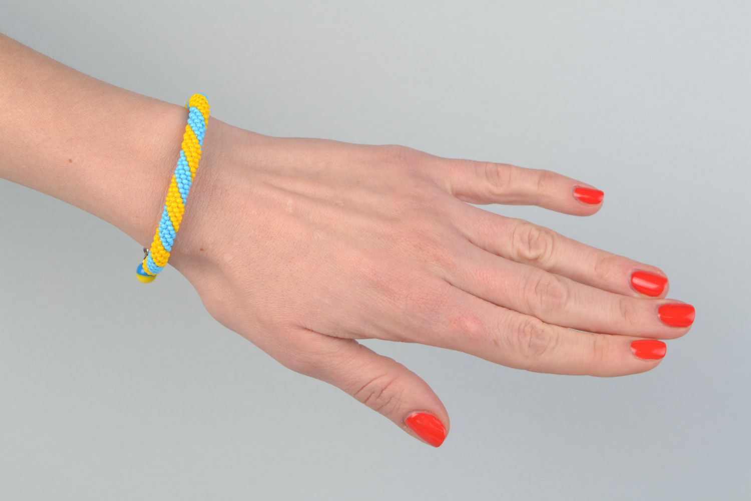 Bright handmade wrist bracelet woven of yellow and blue Czech beads  photo 1