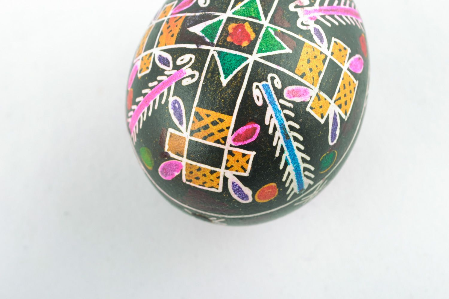 Homemade painted chicken Easter egg with cross pattern on black background  photo 4