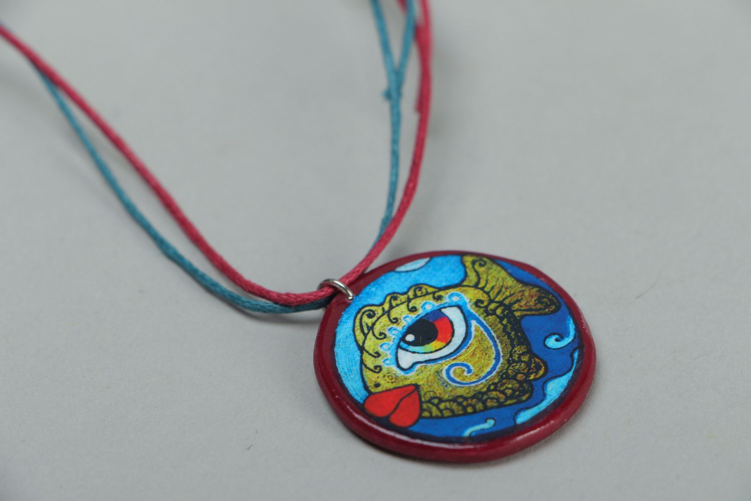 Round polymer clay pendant with drawing on a cord photo 2